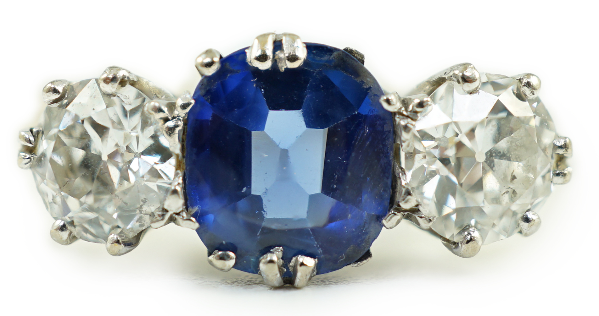 An 18ct gold, single stone oval cut sapphire and two stone round cut diamond set ring